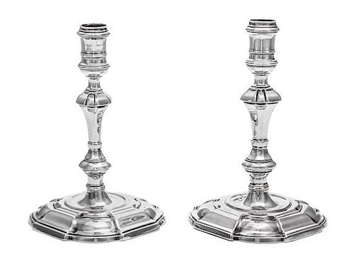 A Near Pair of George II Silver Candlesticks, James Gould, London, 1727 and 1736, each having a banded candle cup above a facete