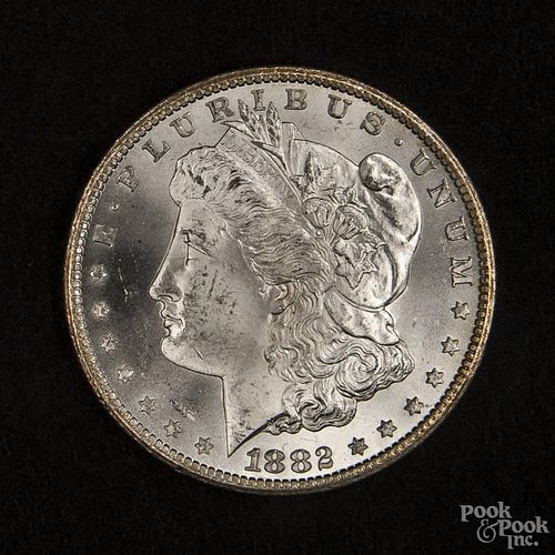 Silver Morgan dollar coin, 1882 CC, MS-63 to MS-64.