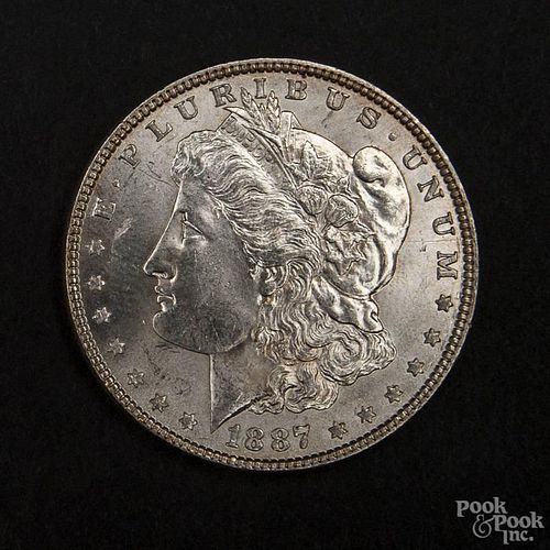 Silver Morgan dollar coin, 1887, MS-63 to MS-64.