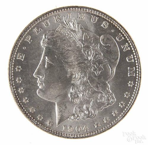 Silver Morgan dollar coin, 1904 O, MS-64 to MS-65.