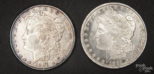 Two silver Morgan dollar coins, 1891 CC, AU-UNC.