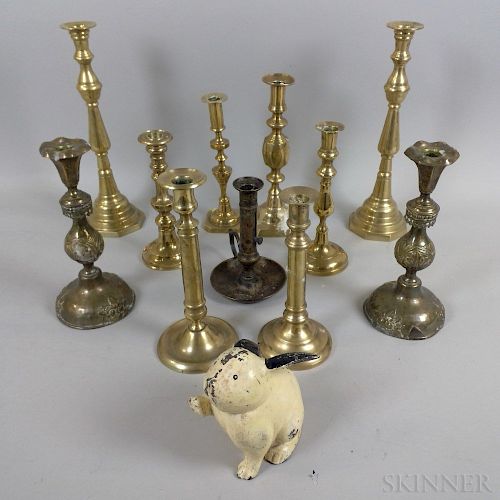 Ten Brass Candlesticks, a Chamberstick, and a Cast Iron Rabbit Doorstop.  Estimate $50-75