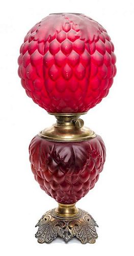 A Victorian Cranberry Glass Oil Lamp, Height 23 inches.