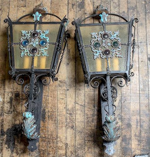 * A Pair of Wrought Metal and Glass Lanterns Height 34 inches.