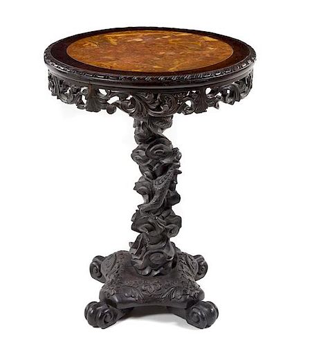 * A Chinese Carved Teak Table Height 29 x diameter of top 21 1/2 inches.
