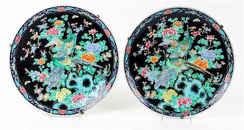 * A Pair of Famille Noir Porcelain Chargers Diameter 14 1/2 inches.