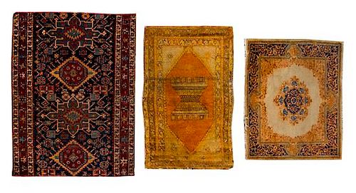 * Three Persian Wool Rugs and Rug Fragments Largest 4 feet 2 inches x 3 feet 9 inches.