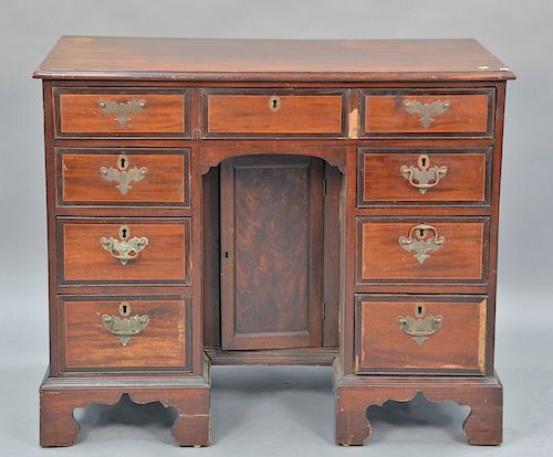 George III mahogany kneehole desk on bracket base, 18th century, ht. 36in., wd. 43in.