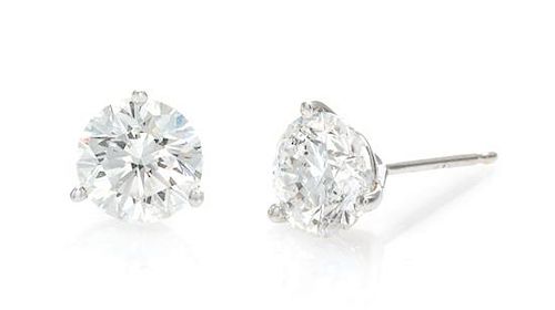 A Pair of 14 Karat White Gold and Diamond Stud Earrings, 1.20 dwts.