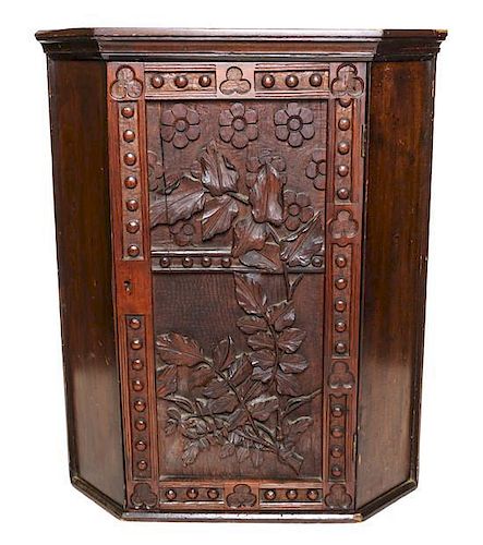 An American Carved Pine Hanging Corner Cupboard, Height 26 x width 21 x depth 14 inches.