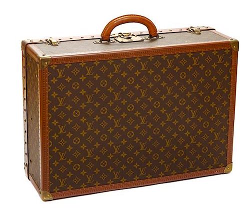 A Louis Vuitton Monogram Canvas Alzer Suitcase, 16" H x 23.5"W x 8.25"D; Handle drop: 2".