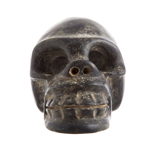 Continental carved stone human skull