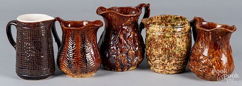 Five molded pottery pitchers