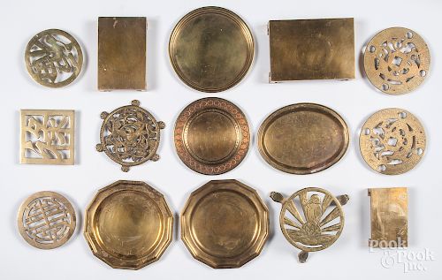 Group of brass trivets and plates.