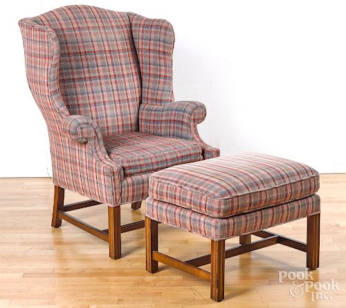 Baker Chippendale style wing chair and ottoman.