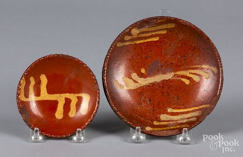 Two small slip decorated redware plates