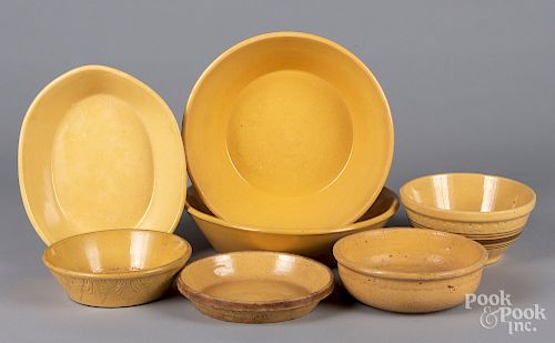 Seven yelloware bowls and serving dishes.
