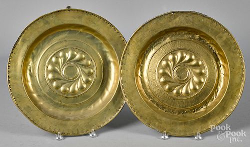 Two embossed brass alms dishes