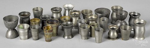 Collection of small pewter measures and beakers