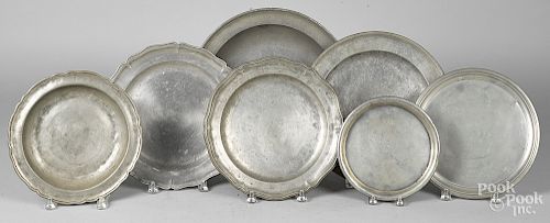 Seven pewter trays, chargers and deep dishes