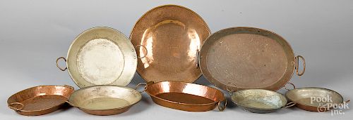 Eight copper trays and serving dishes
