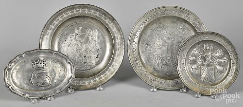 Four pewter trays and chargers