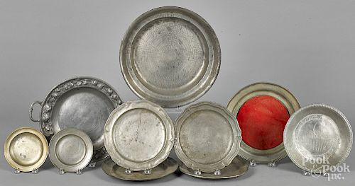 Group of pewter serving dishes and plates