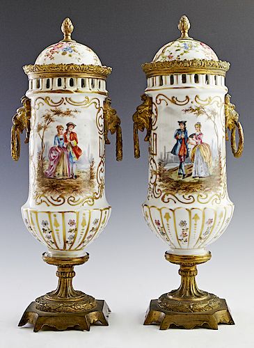 Pair of French Porcelain Gilt Bronze Mounted Covered Urns, early 20th c., of baluster form, the domed lid over a reticulated neck above a side with ap