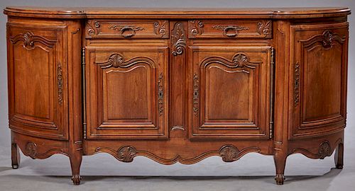 French Louis XV Style Breakfront Walnut Sideboard, 20th c., the shaped stepped top over two setback frieze drawers above two arched fielded panel cupb