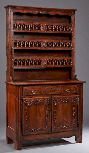 French Provincial Louis XV Style Carved Cherry Vaisselier, c. 1850, the stepped edge crown over three spindled galleried plate racks, on a stepped bas