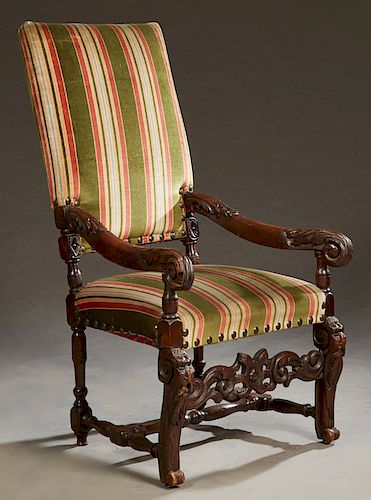 French Renaissance Style Carved Walnut Dining Chair, 19th c., the rectangular high back over a bowed seat, flanked by carved scrolled arms, with lionh