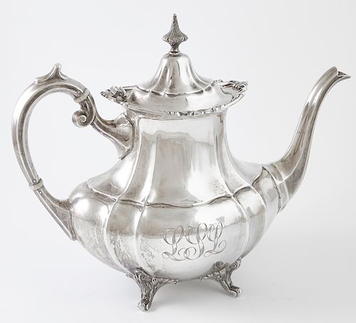 Sterling Teapot, by Reed & Barton, # 660, in the "Hampton Court" pattern, 43 oz., H.- 9 in., W.- 11 in., D.- 5 in., Wt.- 25.25 Troy Oz. Provenance: Pr