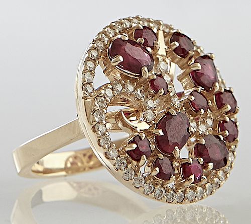 Lady's 14K Yellow Gold Dinner Ring, the pierced top with swirls of rubies and diamonds, within a border of small round diamonds, total ruby weight- 1.