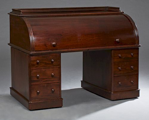 American Carved Mahogany Cylinder Desk, 19th c., the 3/4 gallery top over a cylinder roll, opening to an interior fitted with cubby holes and drawers,