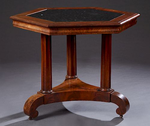 American Carved Walnut Hexagonal Center Table, 19th c., the inset black marble top within a wide border, on three tapered fluted supports to a tripoda