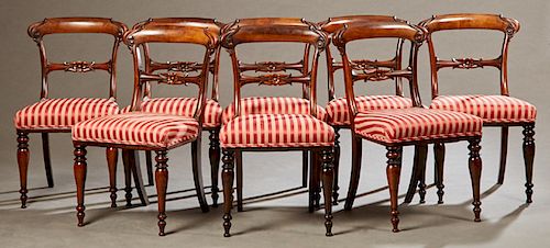 Set of Eight English Victorian Carved Rosewood Dining Chairs, 19th c., the arched curved crest rail over a floral carved horizontal splat, to an uphol
