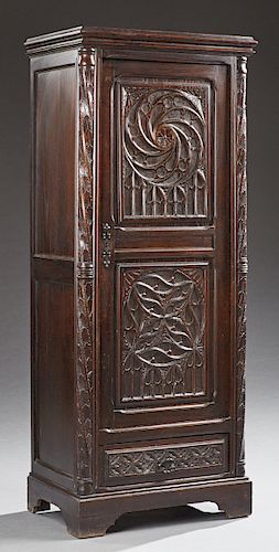 French Carved Oak Neo Gothic Cupboard, late 19th c., the stepped crown over a double panel door with relief Gothic arches and designs, over a bottom d