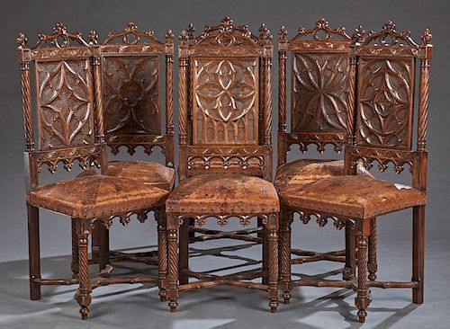 Set of Six French Carved Oak Gothic Style Dining Chairs, 19th c., the arched pierced crest flanked by fleur-de-lis finials, over a rosette carved back