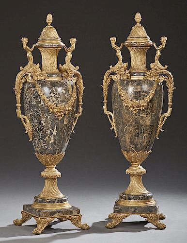 Monumental Pair of French Style Gilt Composition and Marble Veneer Covered Urns, 20th c., of baluster form, the sides with gilt female figural handles