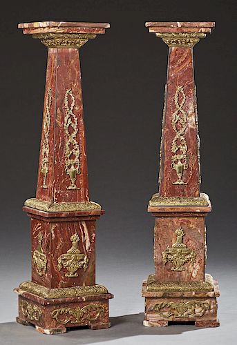 Pair of Neoclassical Ormolu Mounted Rouge Marble Pedestals, 20th c., of tapering forms, the sides mounted with ormolu floral baskets, over ormolu urns