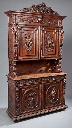 French Henri II Style Carved Oak Buffet a Deux Corps, c. 1881, the carved deer and gryphon crest over a stepped crown above setback double cupboard do