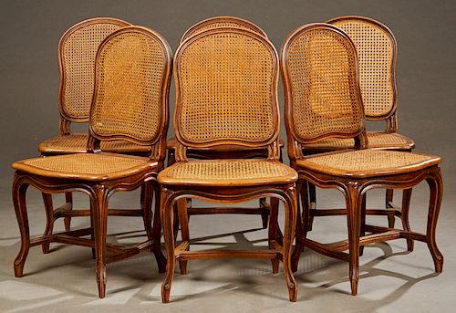 Set of Six French Louis XV Style Carved Walnut Caned Dining Chairs, early 20th c., the shaped medallion caned backs and bowed caned seats, on cabriole