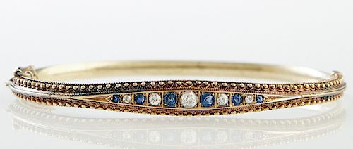English 15K Yellow Gold Hinged Bangle Bracelet, Birmingham, c. 1900, the tapered top with six graduated round sapphires, separated by five graduated r