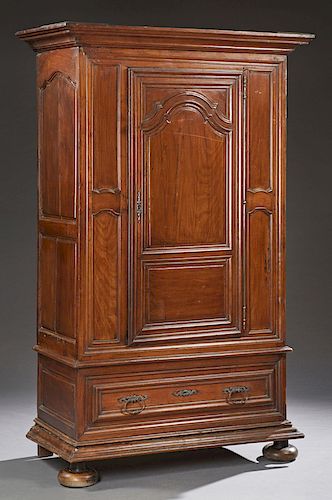 Louis XVI Style Carved Cherry Armoire, 19th c., the stepped crown over an arched fielded panel door, flanked by inset panels, above a single long draw