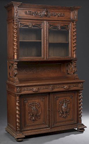 French Carved Oak Henri II Style Buffet a Deux Corps, c. 1880, the stepped breakfront crown over setback glazed doors flanked by rope twist columns on