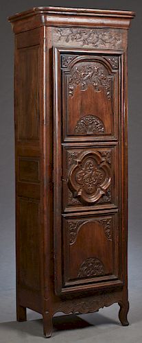 French Renaissance Style Carved Oak Bonnetiere, c. 1850, the stepped rounded corner crown, over a triple panel door with relief floral and bird carvin
