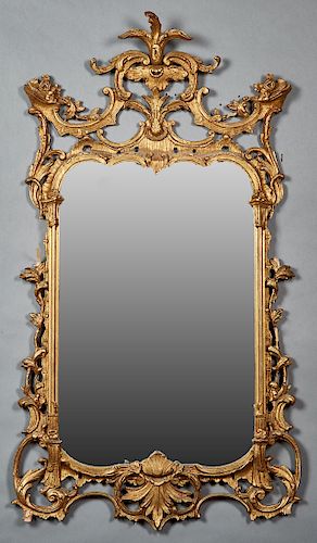 Louis XV Style Gilt Composition Overmantle Mirror, 20th c., with a fleur-de-lis and pierced scrolled crest over a relief decorated frame around an arc