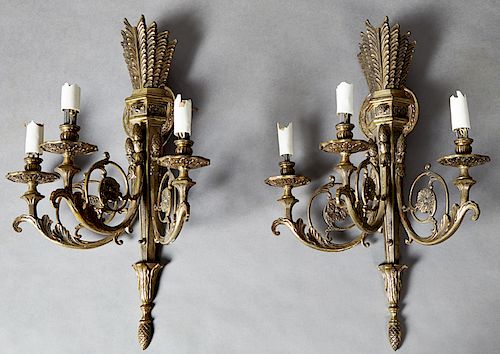Pair of Louis XVI Style Brass Three Light Wall Sconces, 20th c., with a torch and quiver back plate, issuing three scrolled arms with relief bobeches 