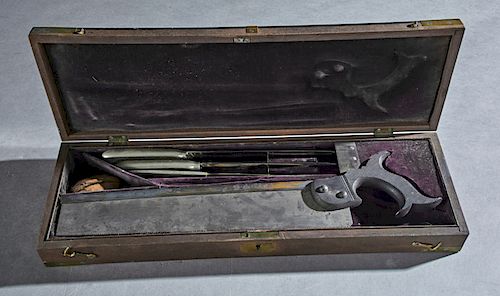 English Cased Amputation Set, c. 1840, consisting of a fitted brass bound mahogany box containing a bone saw, a smaller saw, and two surgical knives m