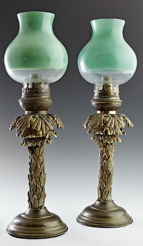 Pair of Continental Gilt Bronze Candlestick Lamps, 19th c., of candlestick form, with a frosted and green glass baluster shade on a relief leaf covere